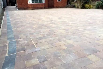 The same Marshalls drive seen from the gate, with a charcoal border along the edge