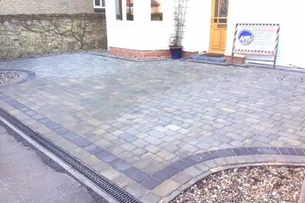 Block-paved drive edged with a channel drain along the road side